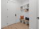 Charming mudroom with a built-in bench, coat hooks, and storage shelves for organization at 7621 Wingfoot Dr, Raleigh, NC 27615