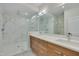 Elegant bathroom with a marble shower, dual sinks, and wooden cabinets at 777 Willard St, Durham, NC 27701