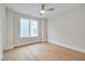 Bedroom features hardwood floors, a ceiling fan, and a large window at 777 Willard St, Durham, NC 27701