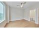 Bright, empty bedroom with hardwood floors, ceiling fan, and an ensuite bathroom at 777 Willard St, Durham, NC 27701