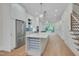 Spacious kitchen with white cabinets, a large island with wine rack, and stainless steel appliances at 777 Willard St, Durham, NC 27701