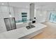 Contemporary kitchen featuring a large island, stainless appliances, and modern lighting at 777 Willard St, Durham, NC 27701