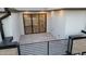 This modern patio features light-colored tile flooring, white walls, and a black metal railing around its perimeter at 777 Willard St, Durham, NC 27701
