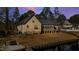 Back of the home with a screened porch next to a lake with dock access at 79 Cove Lndg, Sanford, NC 27332