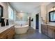 Spa-like bathroom featuring a soaking tub, walk-in shower, and modern fixtures at 83 Stickleback Dr, Willow Springs, NC 27592