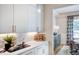 Bright butler's pantry with white cabinets, white countertops, stylish backsplash, and gold accents at 83 Stickleback Dr, Willow Springs, NC 27592