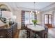 Elegant dining room featuring a modern chandelier, stylish decor, and ample natural light at 83 Stickleback Dr, Willow Springs, NC 27592