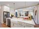 Open-concept kitchen features stainless steel appliances, a large island, and views to the living room at 83 Stickleback Dr, Willow Springs, NC 27592