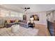 Comfortable living room with a gray sectional, white rug, and modern art at 83 Stickleback Dr, Willow Springs, NC 27592