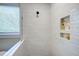 Bright shower with white tile, built-in niche, and glass surround at 83 Stickleback Dr, Willow Springs, NC 27592