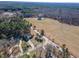Aerial view of the home nestled amongst tall trees on a spacious lot at 10 Georgetown Woods Dr, Youngsville, NC 27596