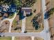 Birds eye view of the home showing the layout of the roof and driveway amidst mature trees and lush landscaping at 10 Georgetown Woods Dr, Youngsville, NC 27596