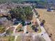 Aerial view of the home nestled amongst tall trees on a spacious lot at 10 Georgetown Woods Dr, Youngsville, NC 27596