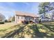 Well-maintained backyard with a deck, lush green lawn, and mature trees, ideal for outdoor enjoyment at 10 Georgetown Woods Dr, Youngsville, NC 27596