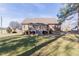 Well-maintained backyard with a deck, lush green lawn, and mature trees, ideal for outdoor enjoyment at 10 Georgetown Woods Dr, Youngsville, NC 27596