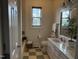 Cozy bathroom featuring a shower/tub, white vanity, and patterned tile floor at 10 Georgetown Woods Dr, Youngsville, NC 27596