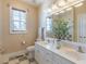 Bathroom featuring double sinks, a toilet, a window, and great lighting from overhead fixtures at 10 Georgetown Woods Dr, Youngsville, NC 27596