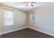 Bedroom featuring natural light from two windows, neutral paint and carpet, and a ceiling fan at 10 Georgetown Woods Dr, Youngsville, NC 27596