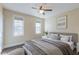 Bedroom featuring natural light from two windows, neutral paint and carpet, and a ceiling fan at 10 Georgetown Woods Dr, Youngsville, NC 27596