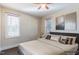 Bedroom featuring natural light from two windows, neutral paint and carpet, and a ceiling fan at 10 Georgetown Woods Dr, Youngsville, NC 27596