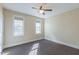 Bedroom featuring natural light from two windows, neutral paint and carpet, and a ceiling fan at 10 Georgetown Woods Dr, Youngsville, NC 27596