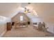 This virtually staged bonus room has a ceiling fan, carpet, window, skylight, and built-in desk, all staged at 10 Georgetown Woods Dr, Youngsville, NC 27596