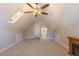 Large carpeted bonus room with ceiling fan, storage space and a rear entry/exit door at 10 Georgetown Woods Dr, Youngsville, NC 27596