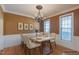 Staged dining room with wainscoting and light-filled windows at 10 Georgetown Woods Dr, Youngsville, NC 27596
