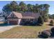 Attractive single-story brick home with attached garage, a covered front porch, and a well-maintained front yard at 10 Georgetown Woods Dr, Youngsville, NC 27596