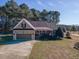 Charming single-Gathering home featuring a brick facade, manicured lawn, and attached garage at 10 Georgetown Woods Dr, Youngsville, NC 27596