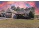 Charming brick home featuring an attached two-car garage, a covered front porch, and neatly kept landscaping at 10 Georgetown Woods Dr, Youngsville, NC 27596
