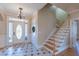 Inviting foyer with tiled floor, staircase and decorative front door at 10 Georgetown Woods Dr, Youngsville, NC 27596