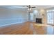 Spacious living room featuring hardwood floors, a fireplace, and a ceiling fan at 10 Georgetown Woods Dr, Youngsville, NC 27596