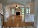 Spacious living room with hardwood floors, fireplace, and abundant natural light at 10 Georgetown Woods Dr, Youngsville, NC 27596