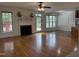 Bright living room featuring a fireplace, hardwood floors, and backyard access at 10 Georgetown Woods Dr, Youngsville, NC 27596