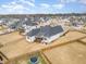 Aerial view of the back of a modern home, with a fenced yard and surrounding neighborhood at 1101 Bessie Ct, Wake Forest, NC 27587