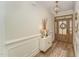 Bright entryway features a wooden front door, chandelier, and decorative accents at 1101 Bessie Ct, Wake Forest, NC 27587