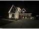 Stunning modern farmhouse featuring designer lighting, manicured landscaping, and inviting covered porch at 1101 Bessie Ct, Wake Forest, NC 27587