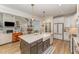 Well-appointed kitchen with an island, modern appliances, and open access to the living room at 1101 Bessie Ct, Wake Forest, NC 27587
