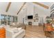 Spacious living room with vaulted ceilings, wooden beams, a cozy fireplace, and modern decor at 1101 Bessie Ct, Wake Forest, NC 27587