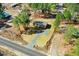 Scenic aerial view of a charming home with a circular driveway, nestled in a wooded area under a partly cloudy sky at 112 Mckoy Town Rd, Cameron, NC 28326