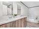 Bathroom featuring double vanity sinks, and a separate tub at 112 Mckoy Town Rd, Cameron, NC 28326
