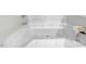 Close up of the bathtub with a white tiled surround, with a flower decoration next to the tub at 112 Mckoy Town Rd, Cameron, NC 28326