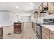 Bright kitchen features an island, stainless steel appliances, and wood-look laminate flooring at 112 Mckoy Town Rd, Cameron, NC 28326
