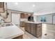Bright kitchen features an island, stainless steel appliances, and wood-look laminate flooring at 112 Mckoy Town Rd, Cameron, NC 28326