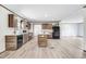 Bright kitchen features an island, stainless steel appliances, and wood-look laminate flooring at 112 Mckoy Town Rd, Cameron, NC 28326