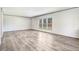 Spacious living room with bright natural light, open floor plan, and wood-look laminate flooring at 112 Mckoy Town Rd, Cameron, NC 28326
