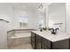 Luxurious bathroom with double sinks, a soaking tub, and a stylish mosaic tile backsplash at 113 Callowhill Ln, Durham, NC 27713