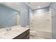 Bright bathroom with vanity, toilet, tub, and blue walls; a serene space for relaxation at 113 Callowhill Ln, Durham, NC 27713