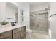 Modern bathroom features a glass-enclosed shower, a single sink vanity, and neutral tiling at 113 Callowhill Ln, Durham, NC 27713